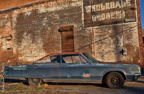 Old car and typo in a downtown industrial area that has long since been abandoned by business