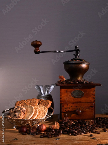 Biscuits and coffee grinder on a gray background