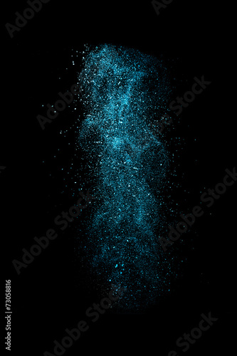 Stop motion of blue dust explosion isolated on black background