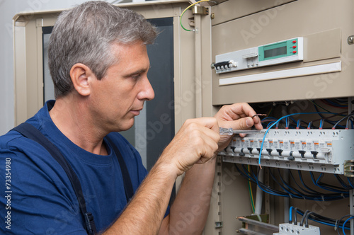 Electrician Repairing A Circuit Breaker