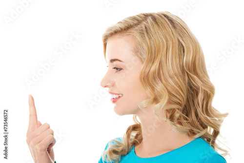Side view of woman looking on her finger