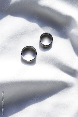 Two wedding ring on white fabric