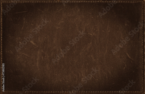 Dark brown grunge background from distress leather texture