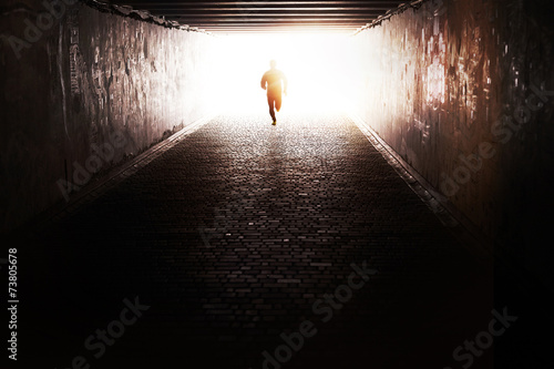 Man running through the tunnel in the sun