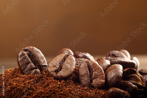 Studio macro coffee beans on the brown background with space for