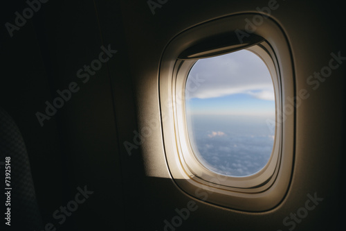 Airplane window with sunlight