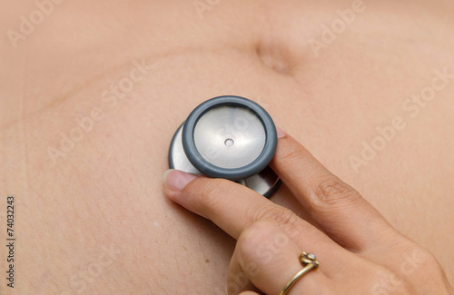 medical auscultation the belly of pregnant woman