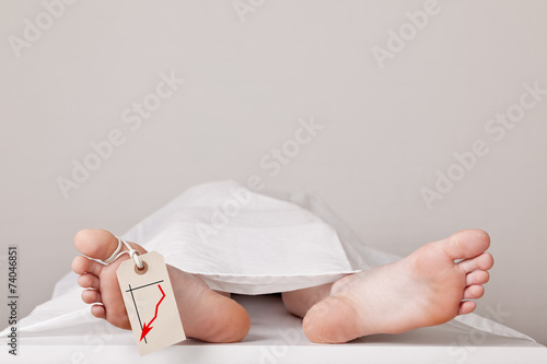 Dead body in the morgue with a chart attached to the toe