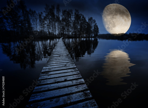 wooden path on a lake and moon