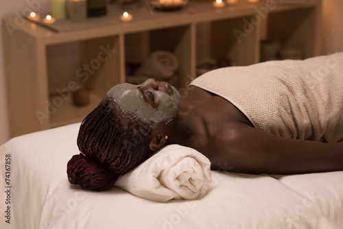 African woman relaxing in spa salon