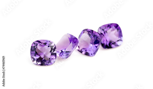 Natural purple amethyst gemstones isolated on white