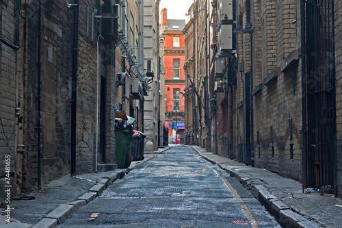 Looking down an empty inner city alleyway