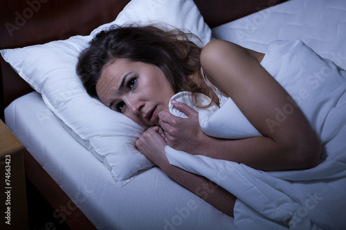 Scared woman trying to sleep