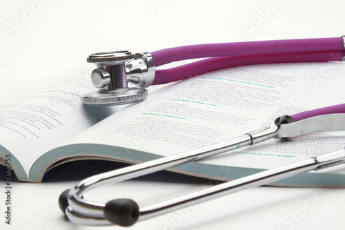 book and stethoscope isolated on white background