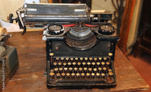 ancient black rusty typewriter with round keys