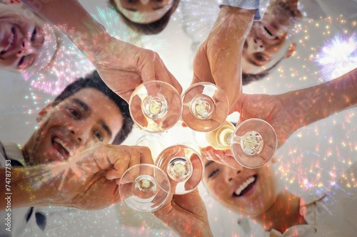 Composite image of casual business team toasting with champagne