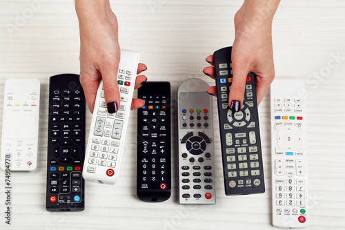 Many remote control devices in hands