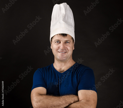 charming chef posing on black background