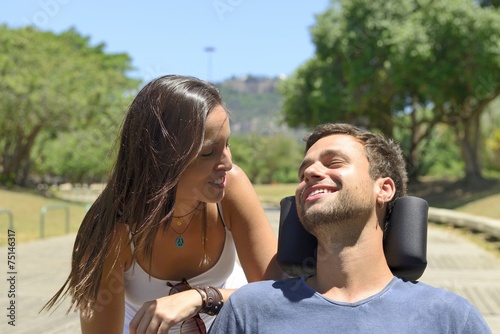 Paraplegic man in wheelchair and girfriend