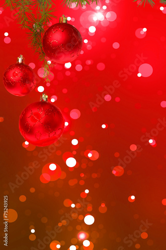 Christmas red balls with green fir tree on colorful red bokeh ba