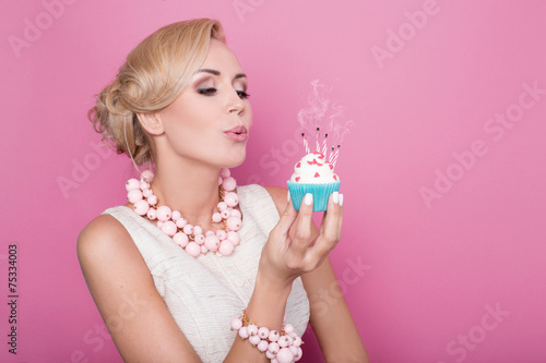 Beautiful women with cream dress holding small cake