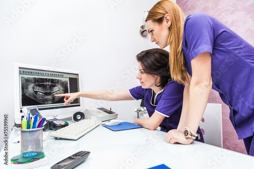 Two Female Dentist Looking At X-ray Image