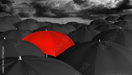 Individuality and different concept of a red umbrella in a crowd