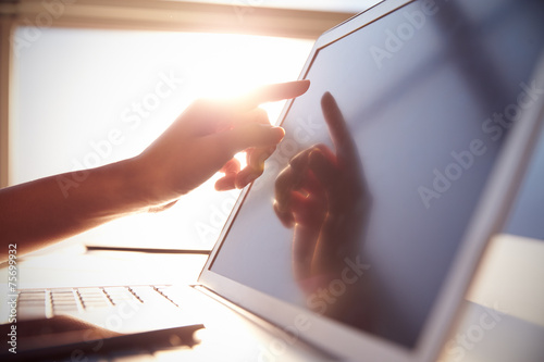 Close Up Hand Touching Laptop Screen With Lens Flare