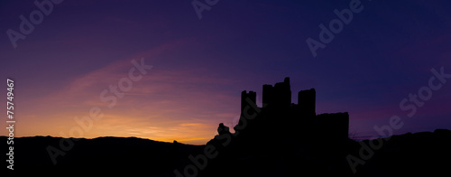 Silouette of Rocca Calascio with dramatic sky at sunset. Abruzzo