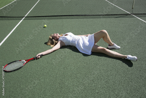 Tennis player on the ground after missing a shot