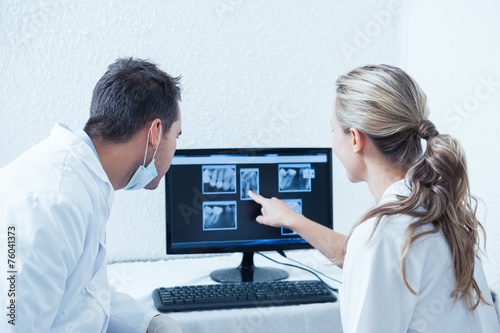 Dentists looking at x-ray on computer