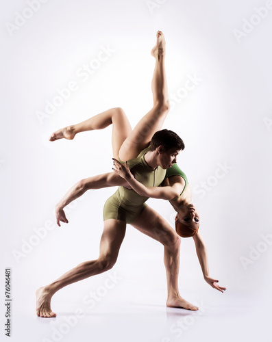 Couple of gymnasts on a light grey background