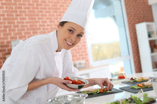 Smiling cook preparing appetizer