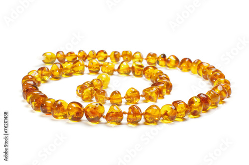 Amber necklace in spiral isolated on the white background