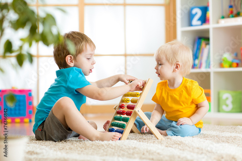 children boys playing with abacus