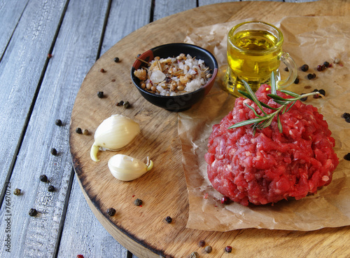 Raw ground beef for burgers cooking with spices