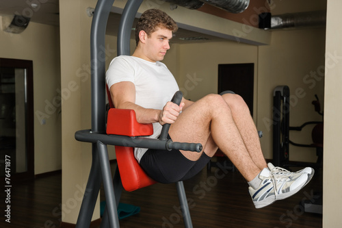 young man doing lats pull-down workout