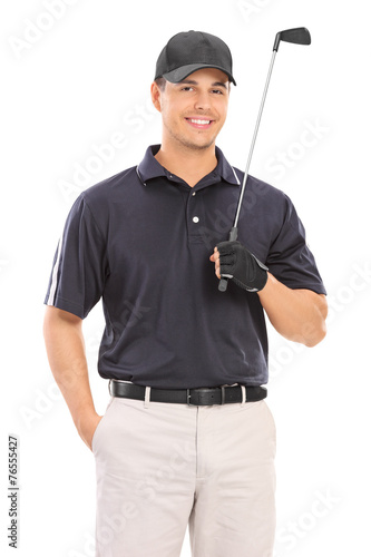 Young professional golfer posing