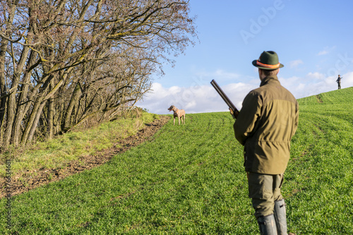 Gamekeeper giving commands to his dog.