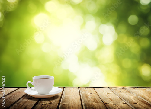 cup coffee and sunny trees background