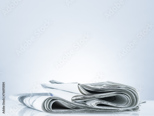 Folded newspaper.On blank desk.