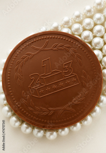 Chocolate medal on white pearl