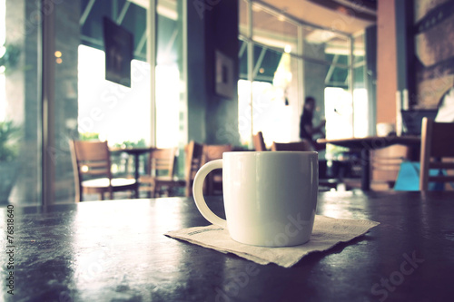 vintage color tone of cup of coffee on the table coffee shop