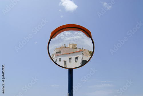 Building reflects in a street mirror in Ferragudo, Portugal.