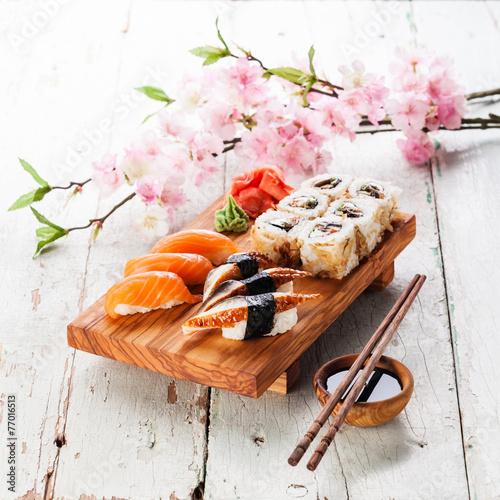 Sushi Set: sashimi and sushi rolls on blue background