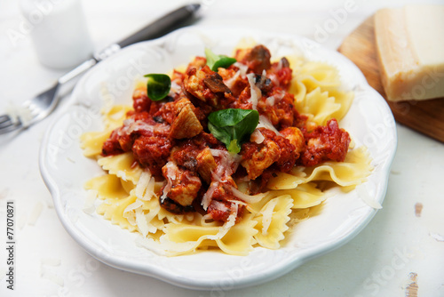 Farfalle pasta with chicken, tomato sauce and mushrooms