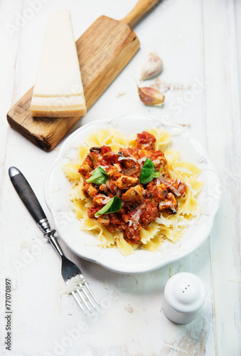 Farfalle pasta with chicken, tomato sauce, mushrooms