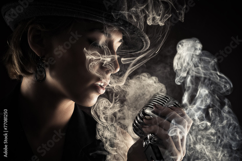 singer woman with retro microphone in smoke