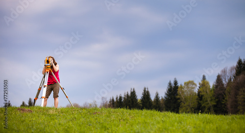 Young land surveyor at work.