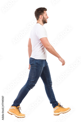 Young man walking in jeans and white t-shirt